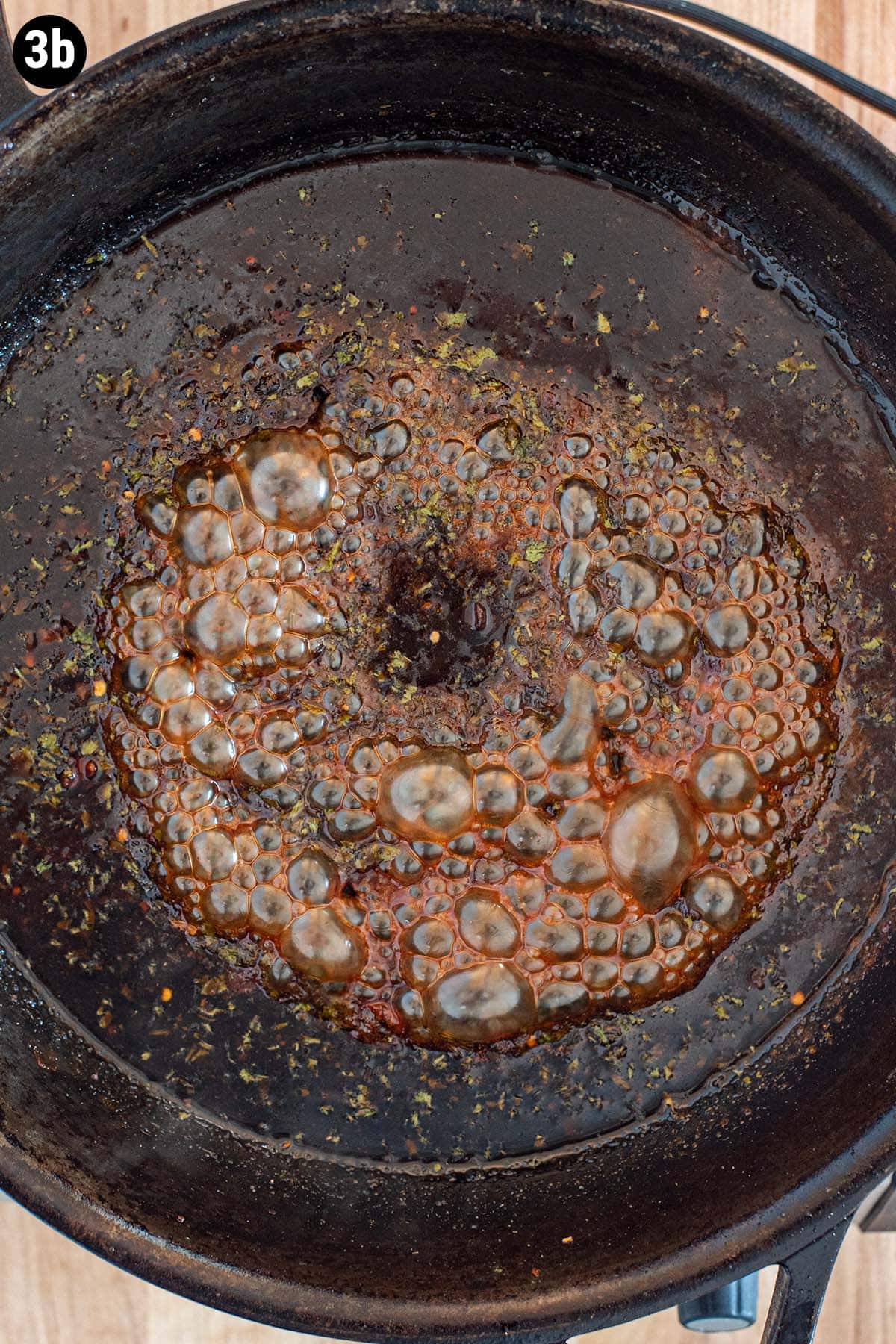 Bubbling cilantro lime marinade in a cast iron skillet.