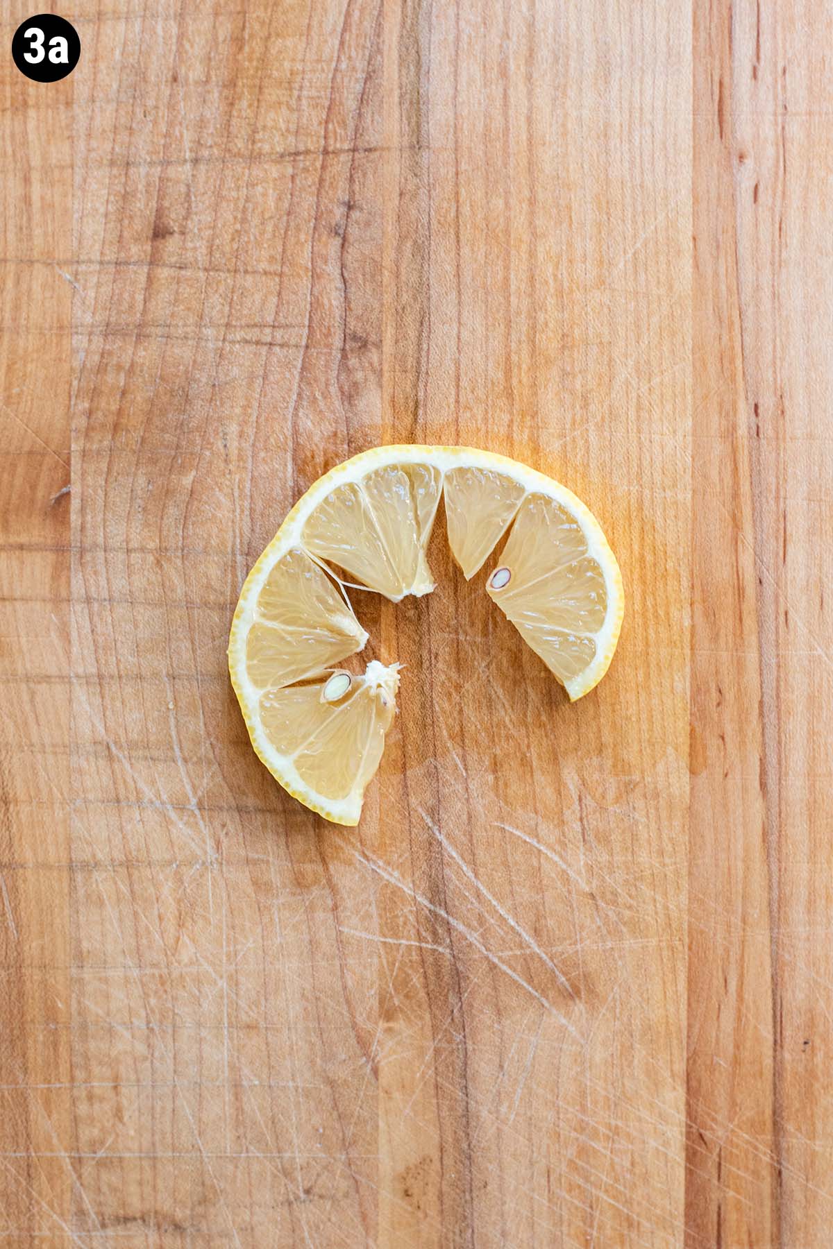 A sliced lemon wheel that has been sliced and spread apart.