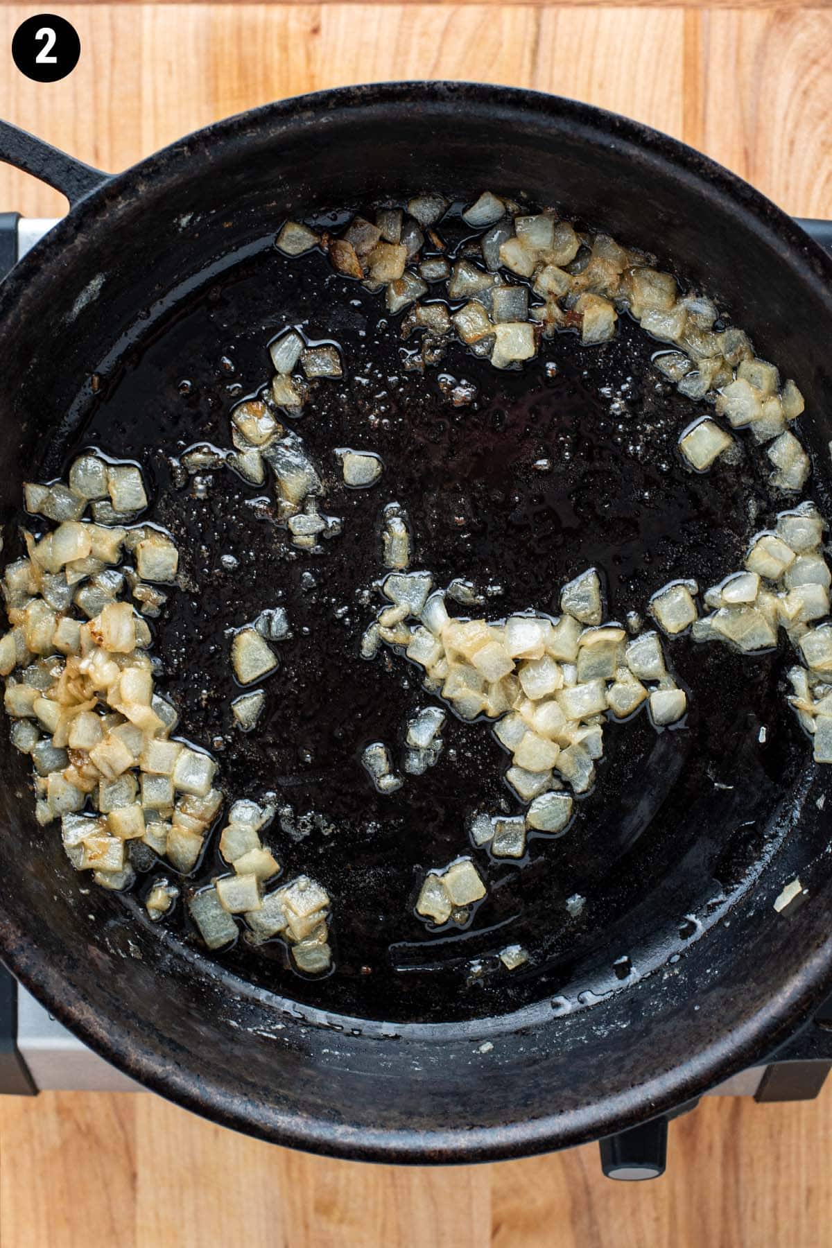 Softened onion with butter in a cast iron skillet.