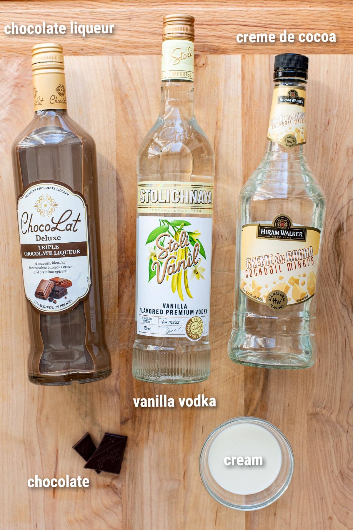 Chocolate martini ingredients laid out on a wooden cutting board.