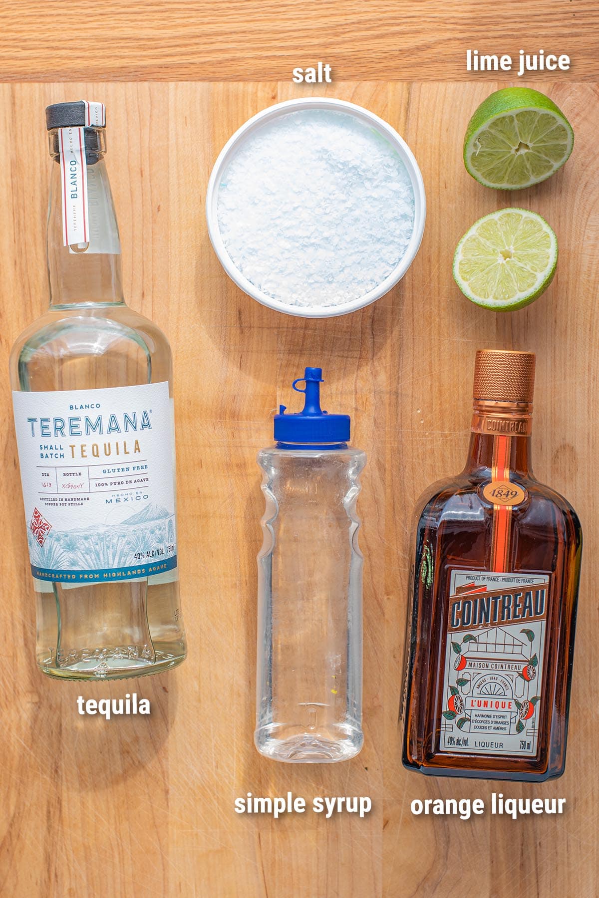 Classic margarita ingredients laid out on a cutting board.