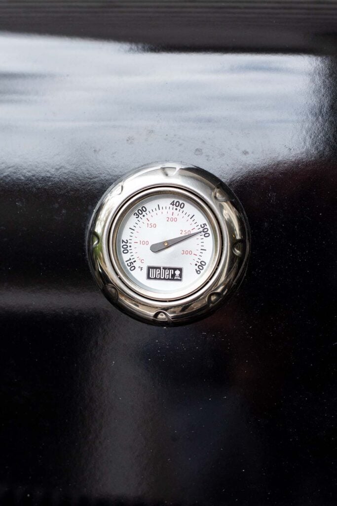 A Weber grill thermometer reading 500 degrees Fahrenheit.