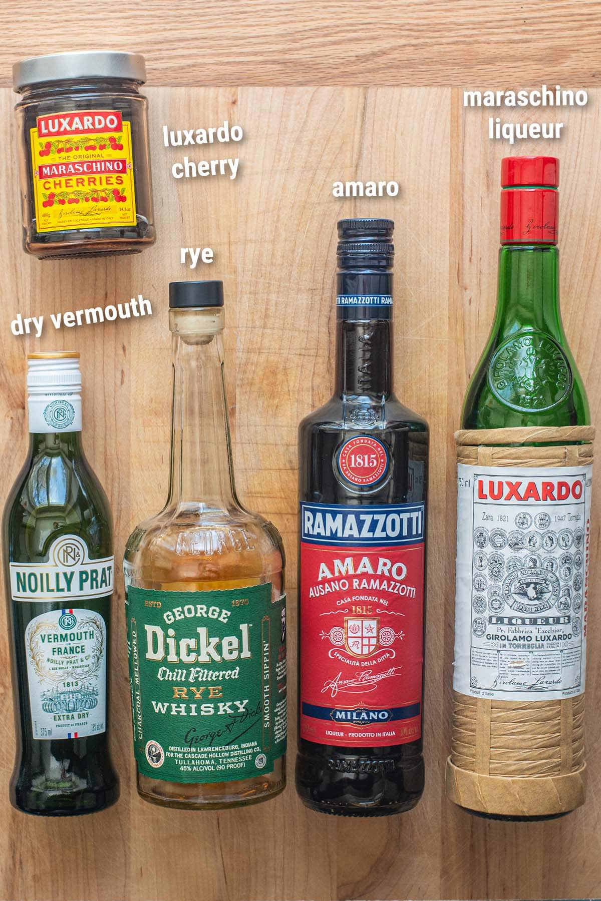 Brooklyn cocktail ingredients laid out on a wooden cutting board.