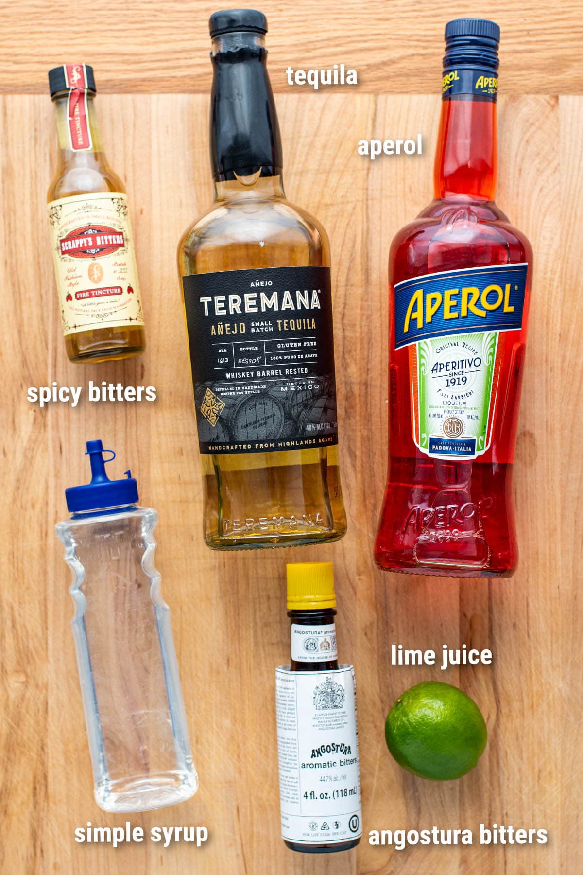 El Chipilo cocktail ingredients laid out on a wooden cutting board.