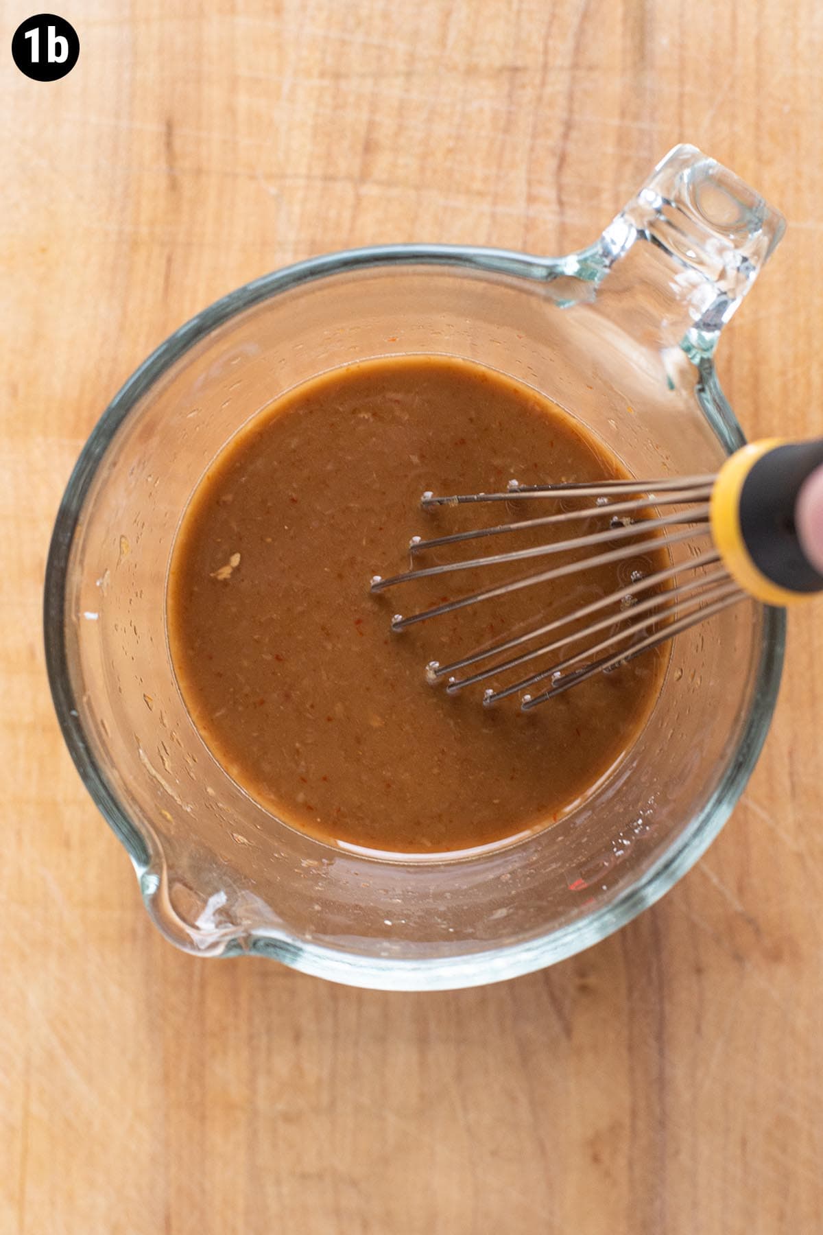 Beef and broccoli sauce ingredients mixed together in a glass measuring cup.