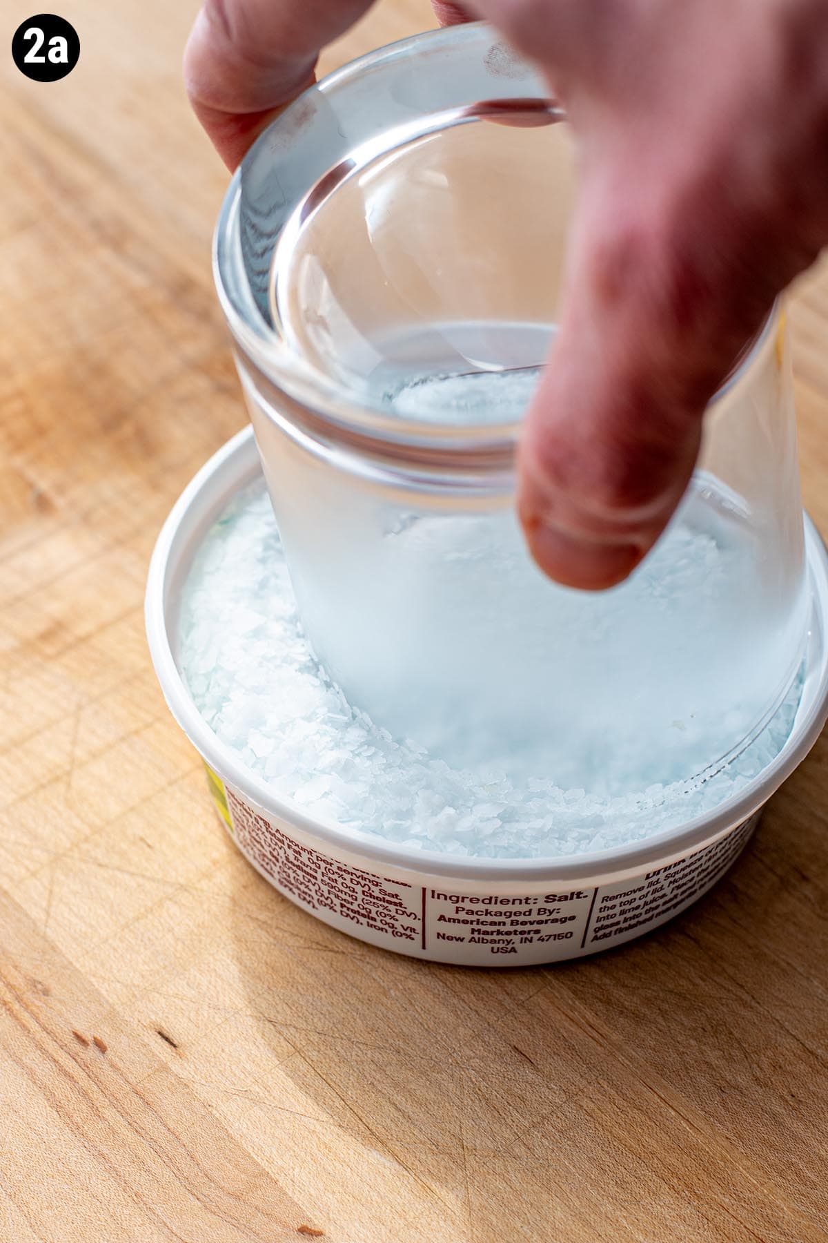 Dipping the rim of a chilled glass into margarita salt.