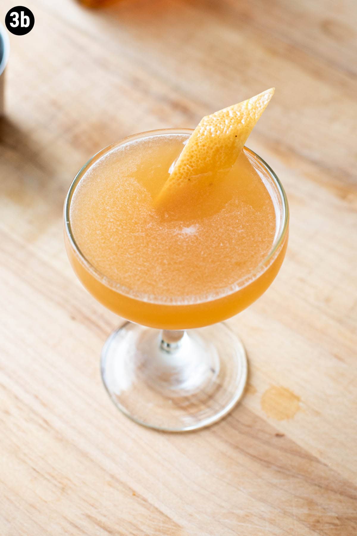 A Brown Derby cocktail served in a chilled coupe glass garnished with a grapefruit peel.