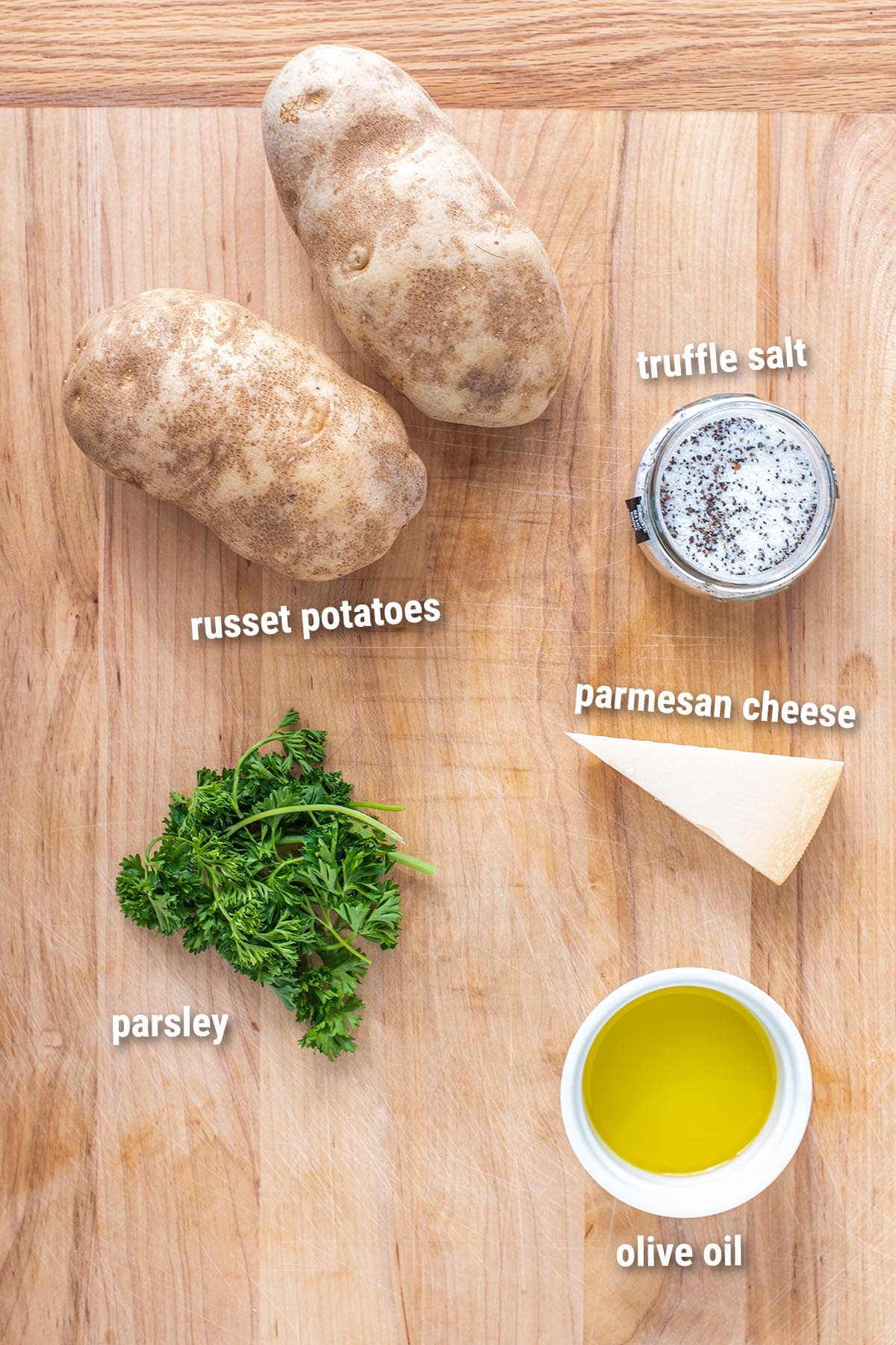 Raw, uncooked, truffle fries ingredients laid out on a cutting board.