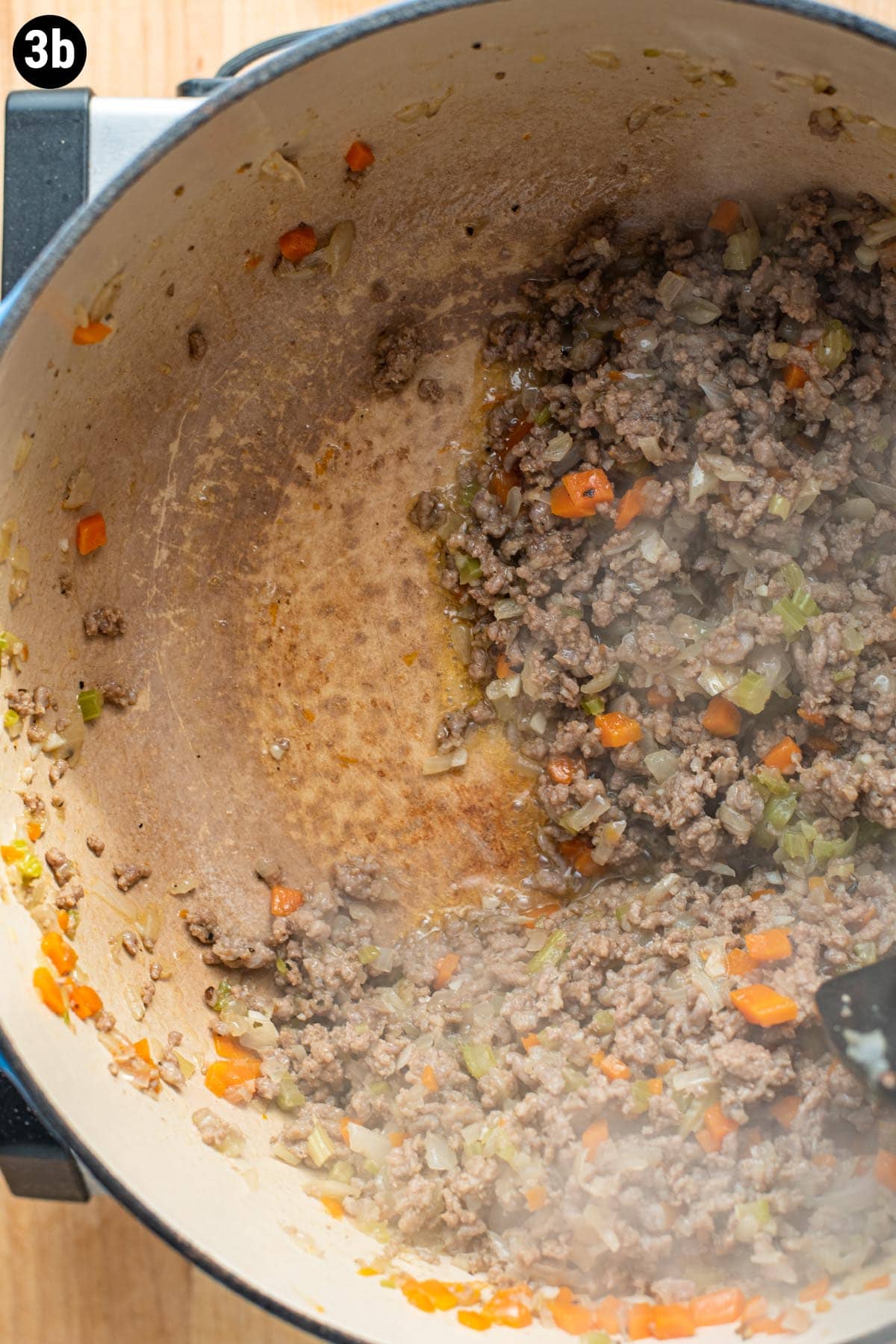 Bolognese beef mixture in a Dutch oven after the pan has been deglazed.