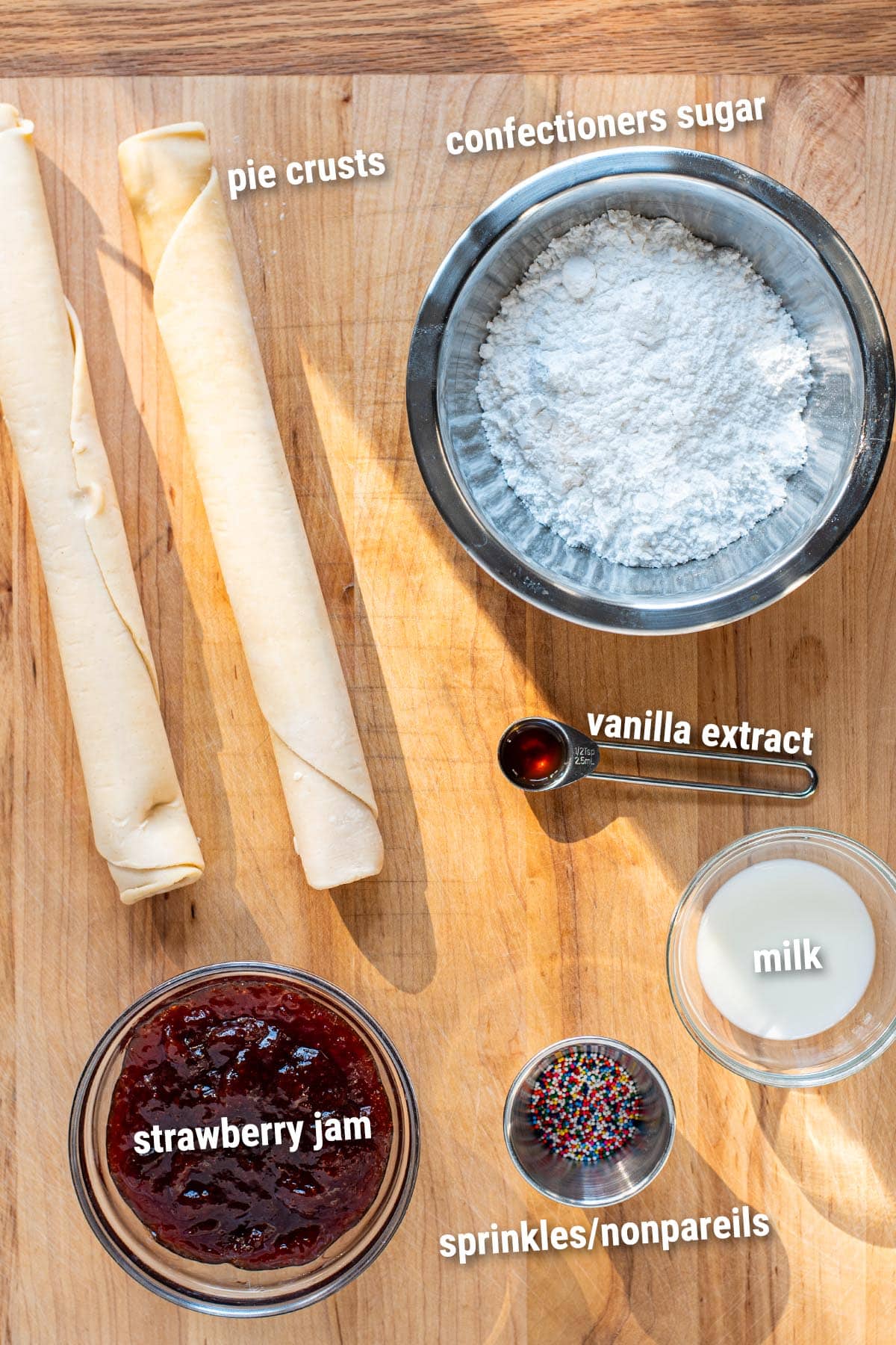 Raw, uncooked skillet Pop Tart ingredients laid out on a wooden cutting board.