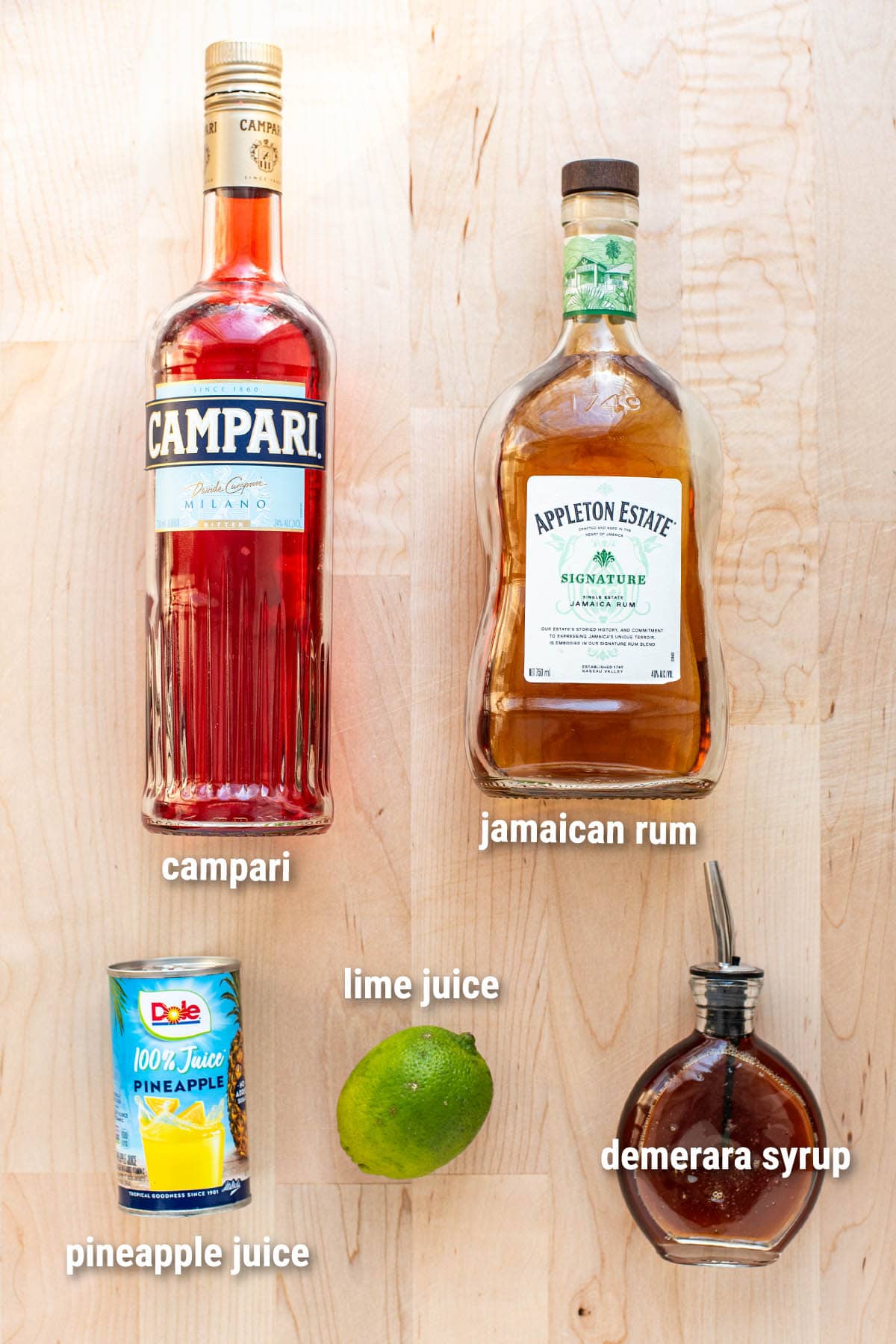 Jungle Bird cocktail ingredients laid out on a wooden cutting board.