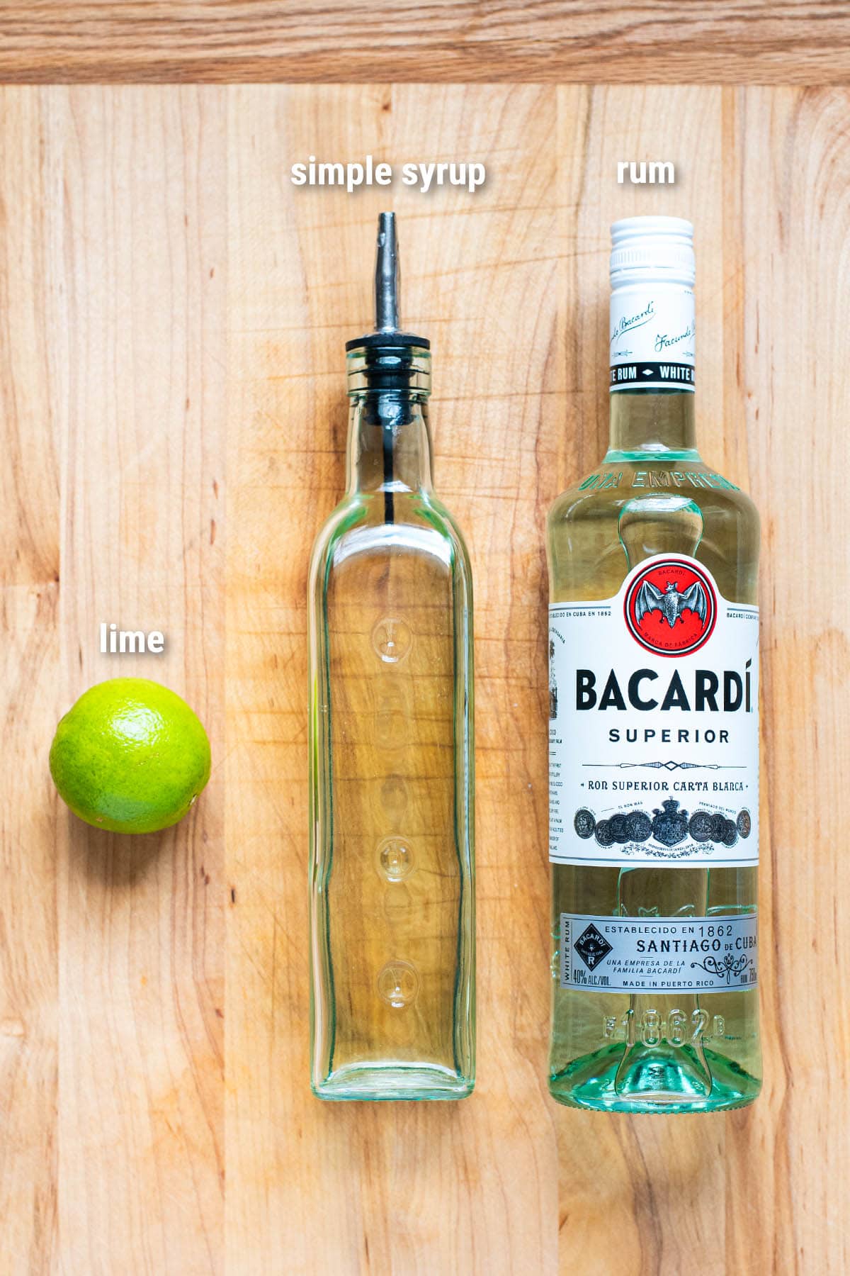 Daiquiri cocktail ingredients laid out on a wooden cutting board.