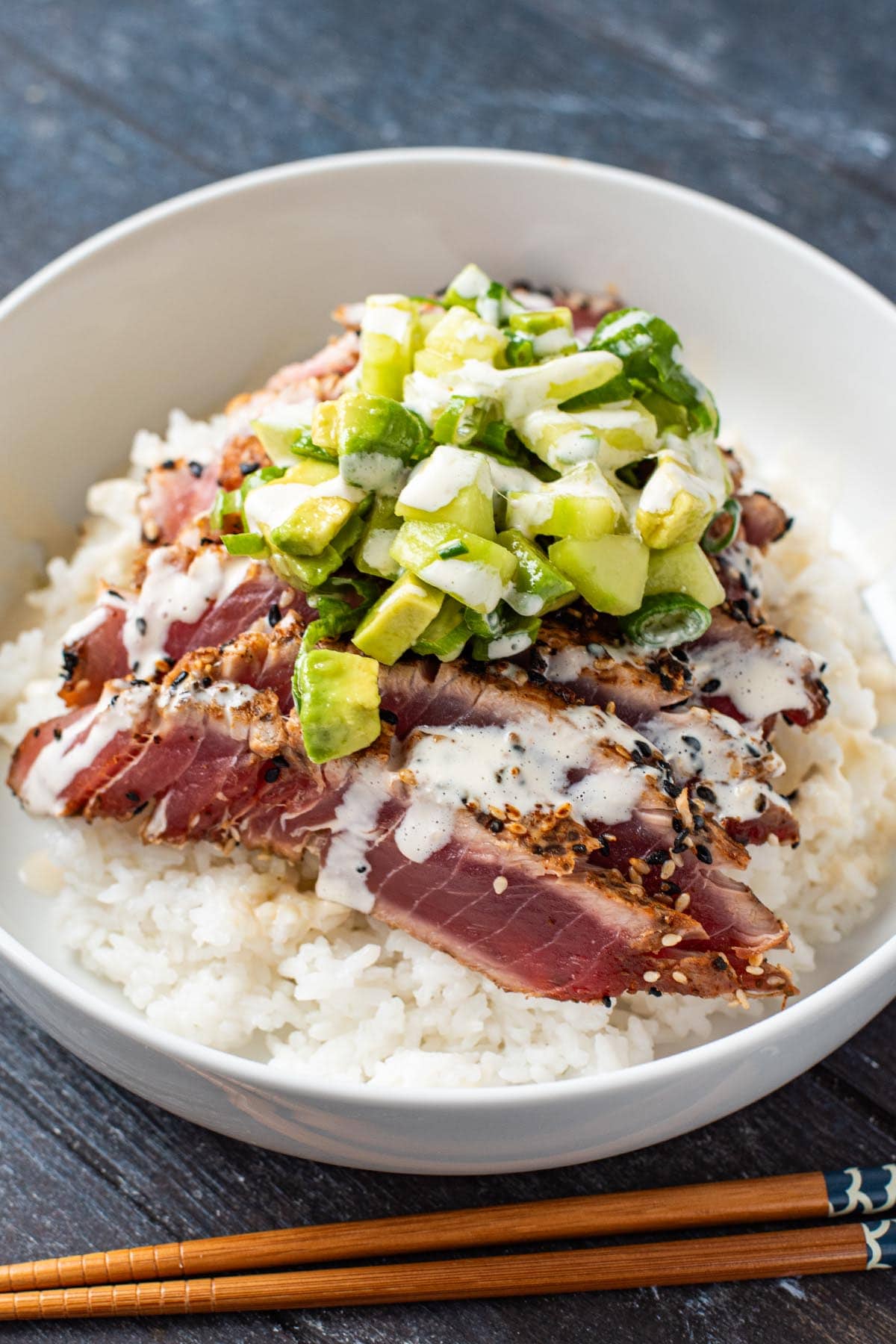 Seared Ahi tun topped with cucumber avocado salad and a ginger soy sauce mayo.