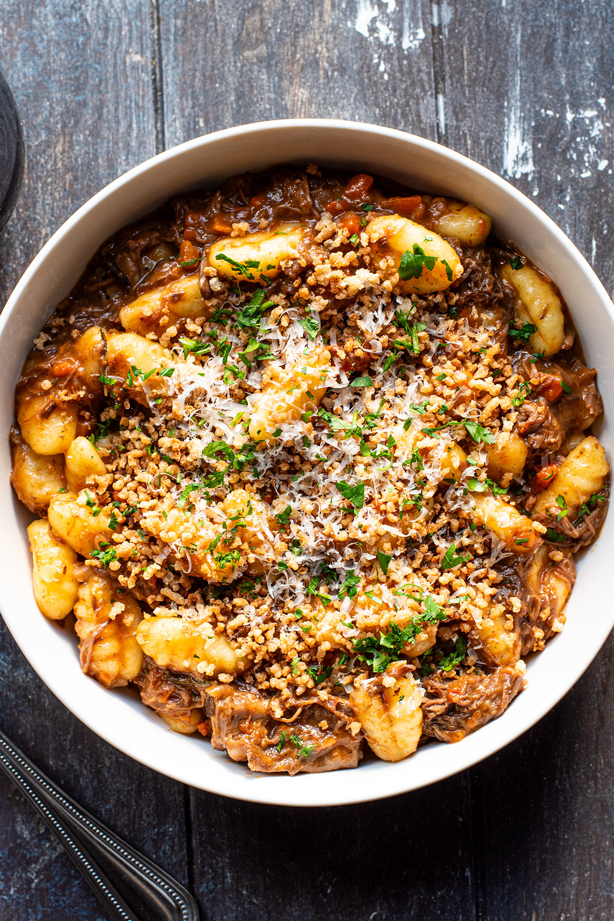 Braised short ribs served with potato gnocchi topped with golden panko crumbs and parmesan cheese.